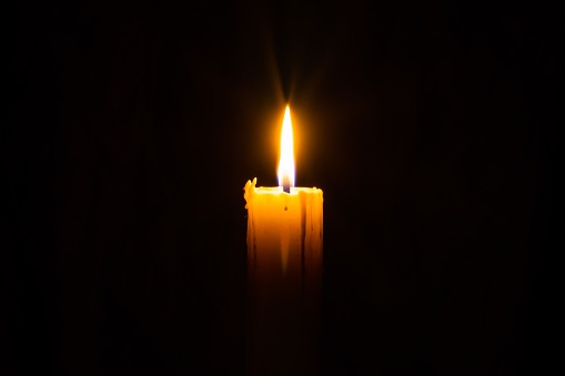 Woman lights candles in church