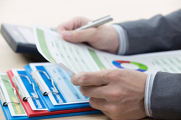 istock businessman analysing a set of bar and pie graphs 539150663
