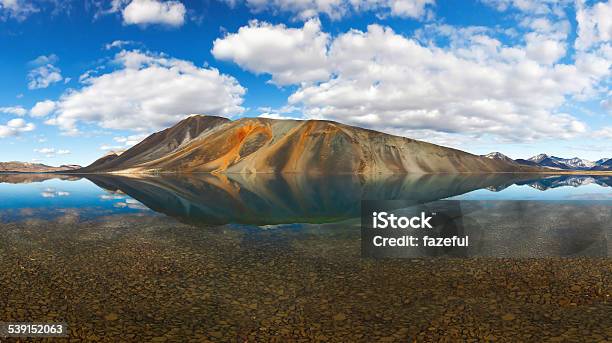 Reflection Of Colorful Mountain Behind Transparent Lake In Chukotka Stock Photo - Download Image Now