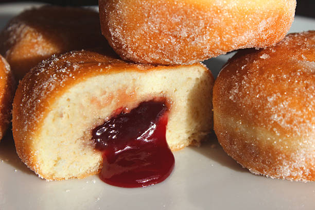 istock Image of fresh jam doughnuts / jelly donuts, with caster sugar 539167615