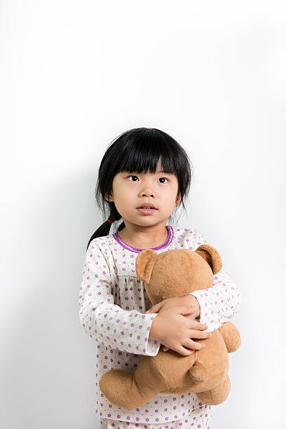 istock Little Asian girl with teddy bear 539181439
