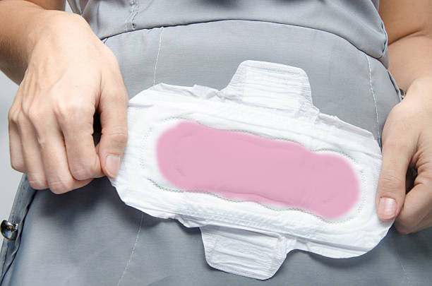 istock woman's hands holding a sanitary pad on green background close-u 539181767