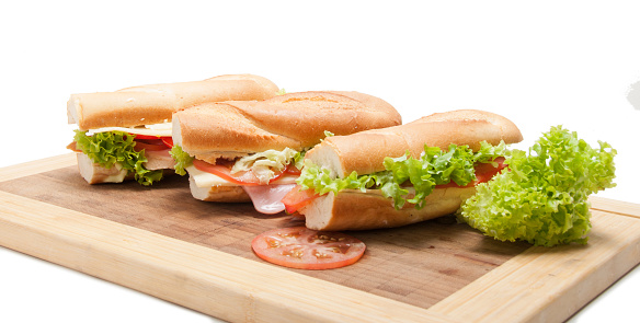 Big fresh baguette sandwich isolated on the white background