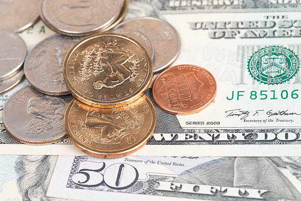 istock US coins on US banknotes close up 539182815