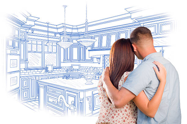 istock Young Military Couple Looking Over Custom Kitchen Design Drawing 539183269