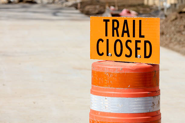 Trail Closed Orange Sign on Concrete