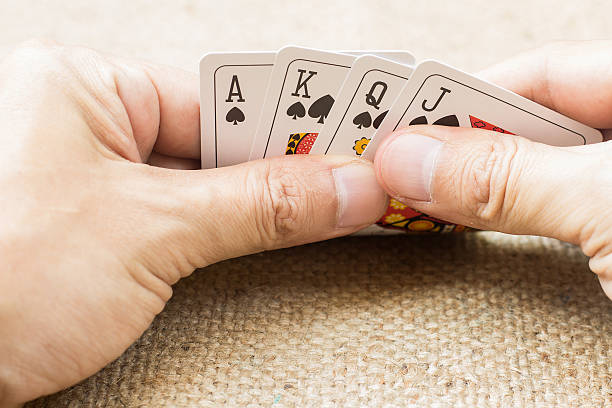 istock Closeup of hands with playing cards 539183459