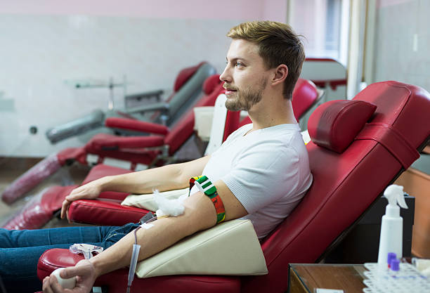 Man giving blood donation Man Blood Donor Making Donation In Hospital blood plasma photos stock pictures, royalty-free photos & images