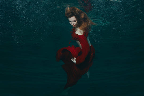 istock Woman in red dress underwater. 539204132