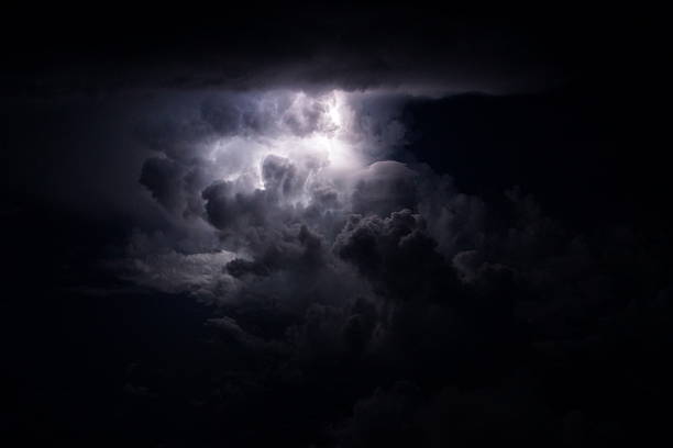 Thunderstorm over the sea with lightning bolts Thunderstorms over the Caribbean sea with big vertical development and lightning bolts. Microburst stock pictures, royalty-free photos & images