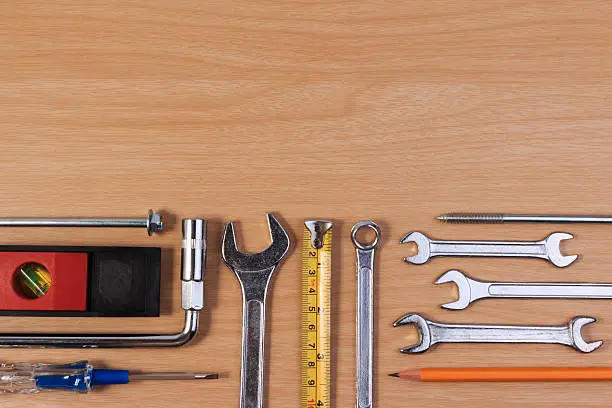Photo of Engineer tools, wrench tools on wood table.