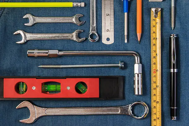 Photo of Wrench tools on a denim workers. Flat lay style.