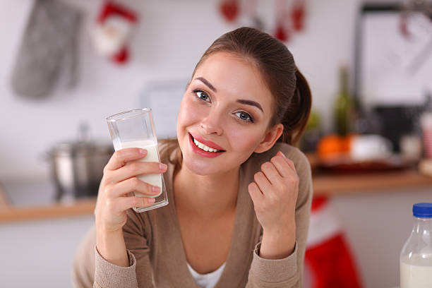 istock Smiling attractive woman having breakfast in kitchen interior 539204811