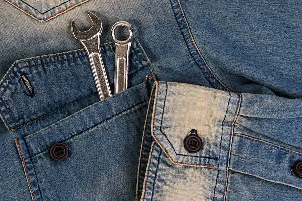 Photo of Wrench tools on a denim workers, A jeans with tools.