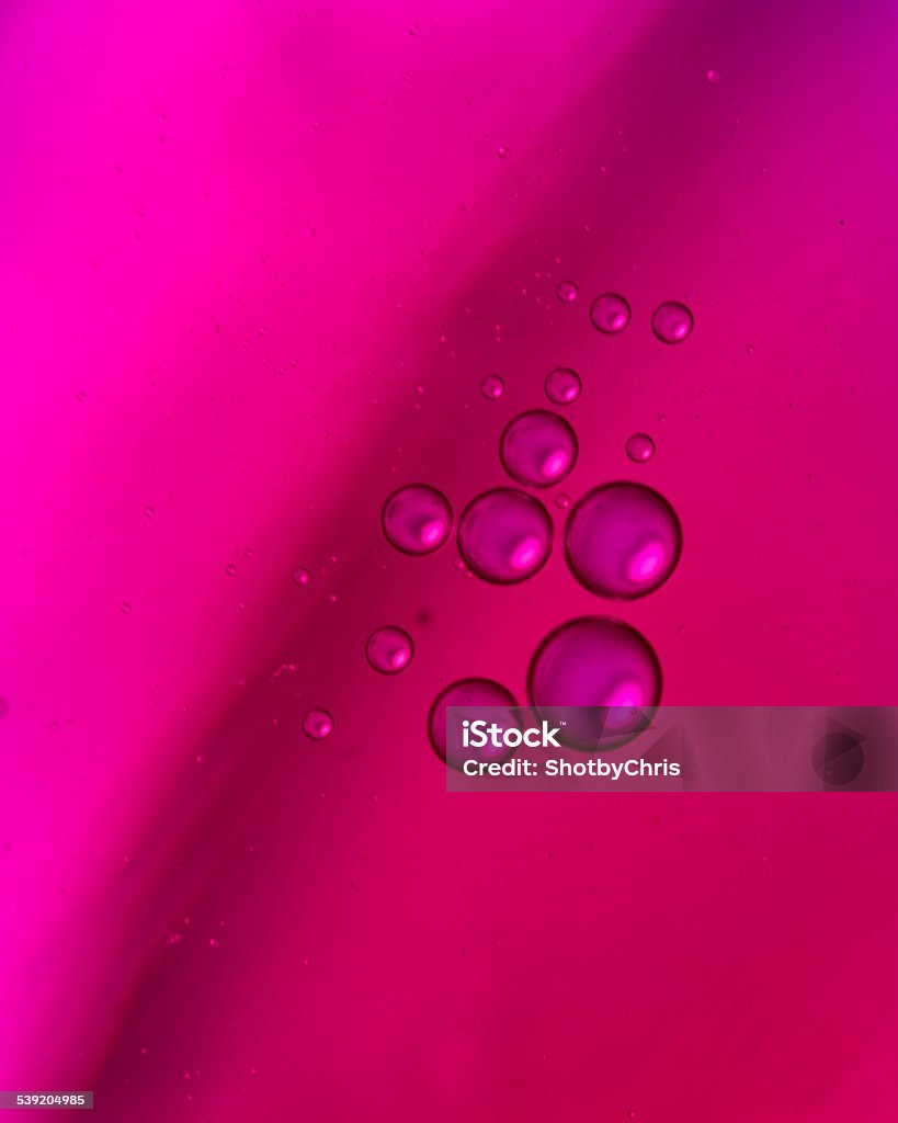 Purple Oil in Water Purple oil droplets in water on a purple background 2015 Stock Photo