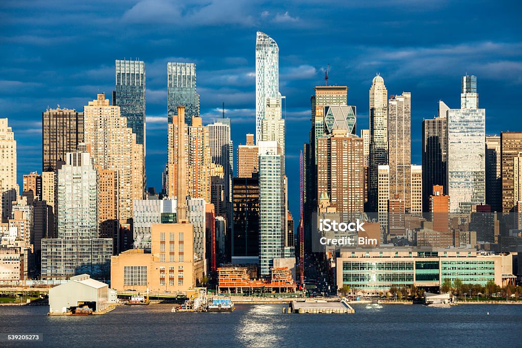 Midtown Manhattan Skyscrapers, New York Midtown Manhattan skyscrapers in sunset light, view from Jersey City over Hudson River, dramatic cloudy blue sky, horizontal, America, USA 2015 Stock Photo