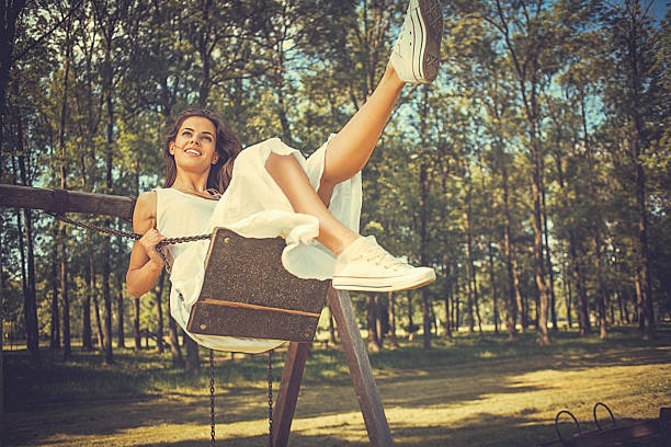 istock Happy young woman having fun on the swing 539205495
