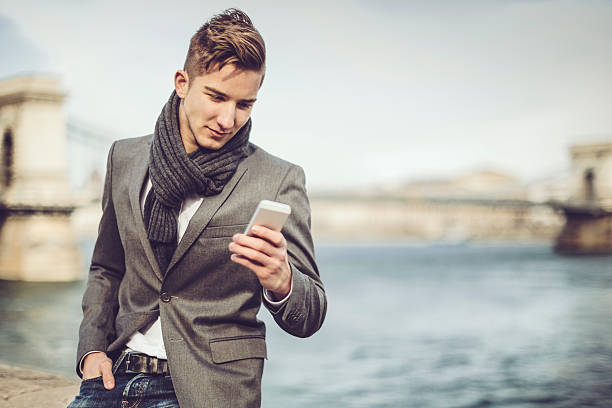 istock Young and trendy man is texting on the phone 539205651
