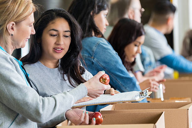 istock Diverse volunteers sorting donated food into boxes during can drive 539205717
