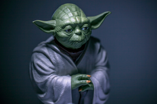 istanbul, Turkey - February 24, 2015: Portrait of Jedi Master Yoda toy model, from director George Lucas's legend Star Wars Film. Shot on dramatic dark background.