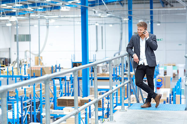 istock Manager at factory talking on mobile phone 539206433