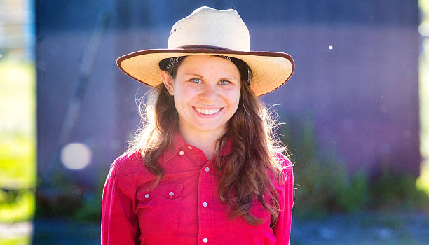 istock Beautiful female ranch employee lit by sunset 539206545
