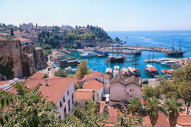 Famous old harbor in Antalya with boats, ships and yachts anchored in it.