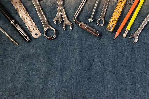 Photo of Wrench tools on a denim workers,