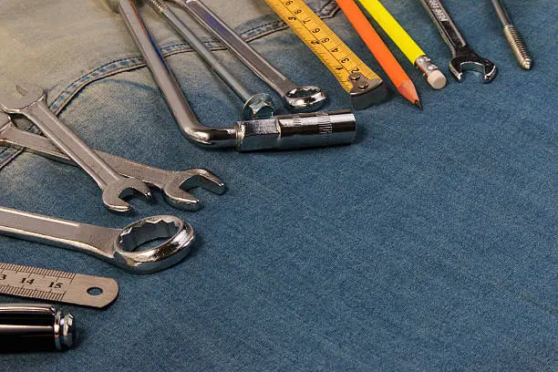 Photo of Wrench tools on a denim workers,