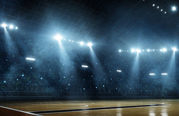 Basketball arena Indoor floodlit basketball arena full of spectators - full 3D stadium stock pictures, royalty-free photos & images