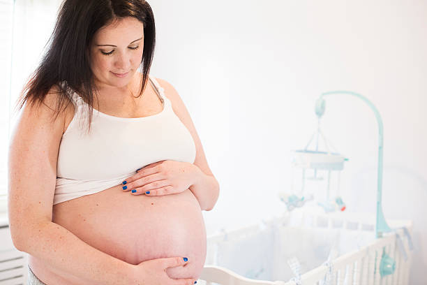istock Pregnant woman in baby's nursery 539208403