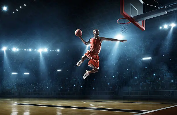 Photo of Basketball player makes slam dunk