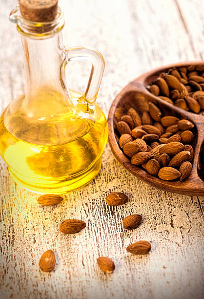 istock Almond oil in glass bottle and almonds 539208449
