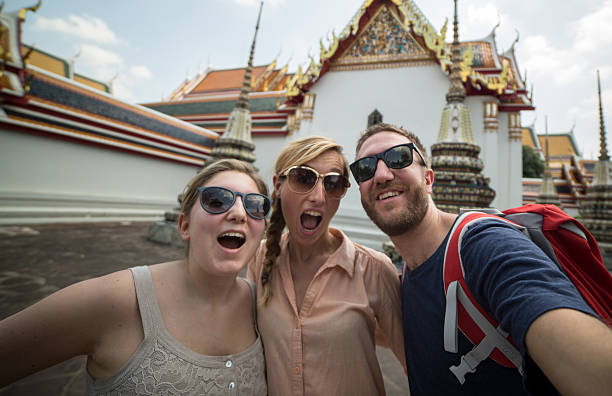 istock Funy young people taking selfie with temples in Thailand 539208511