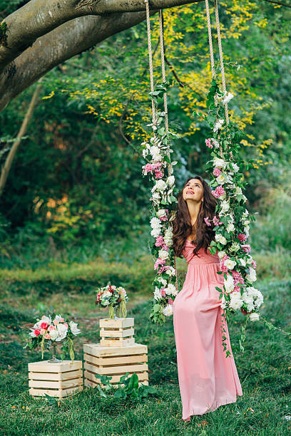 istock Beautiful young girl on a swing 539208749