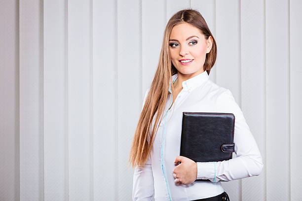 istock Young woman office worker hold case with files. 539211810
