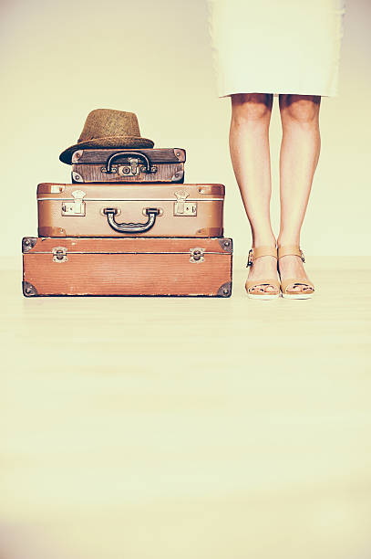 istock Woman standing beside suitcases 539211916