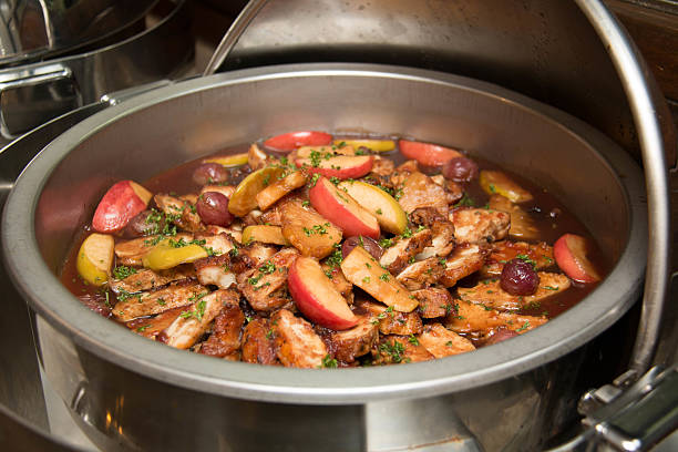 Roast pork slice with gravy sauce and fruit on top in dish