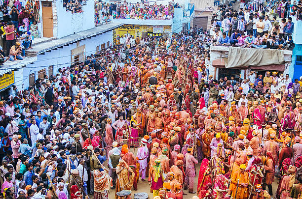 Holi Festival celebration, Barsana, Rajasthan, India crowd of villagers celebrate Holi , women beat men with sticks india crowd stock pictures, royalty-free photos & images