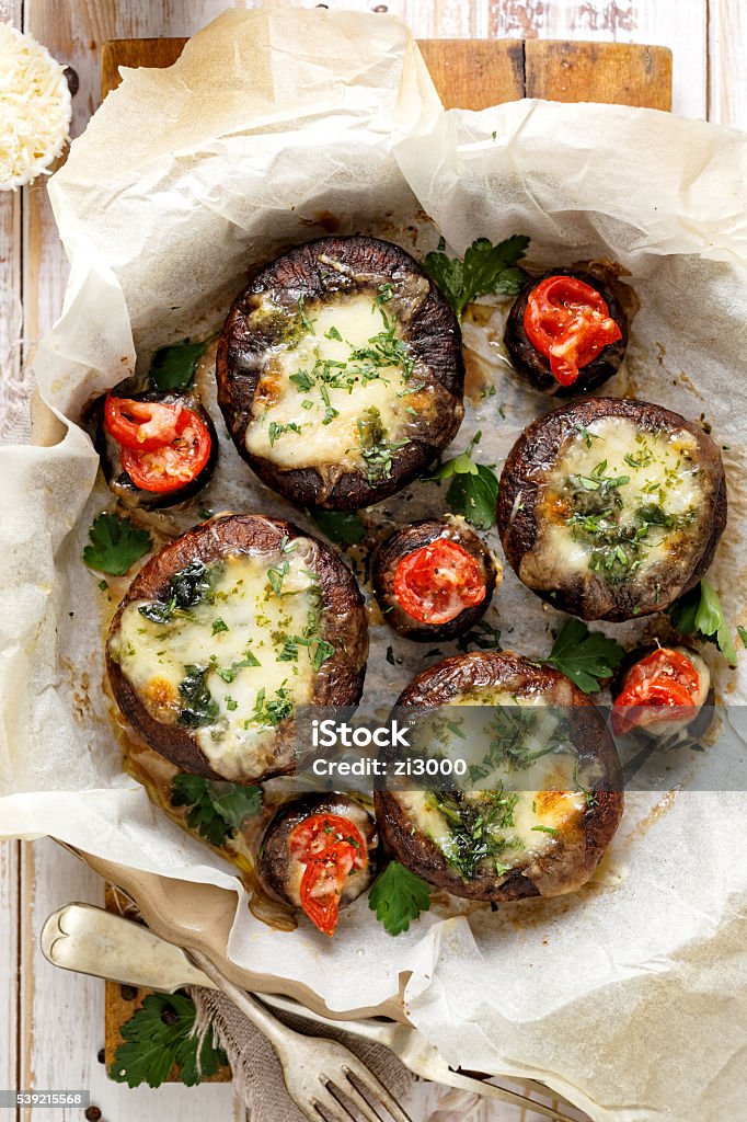 Portobello mushrooms stuffed with spinach and cheese Delicious and nutritious vegetarian dish with organic products, portobello mushrooms stuffed with spinach and cheese, top view Edible Mushroom Stock Photo