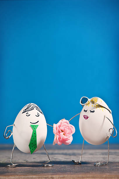 A man egg giving a woman egg a flower.