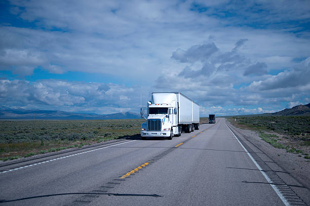 istock Big rigs semi trucks black and white on Nevada road 539215712