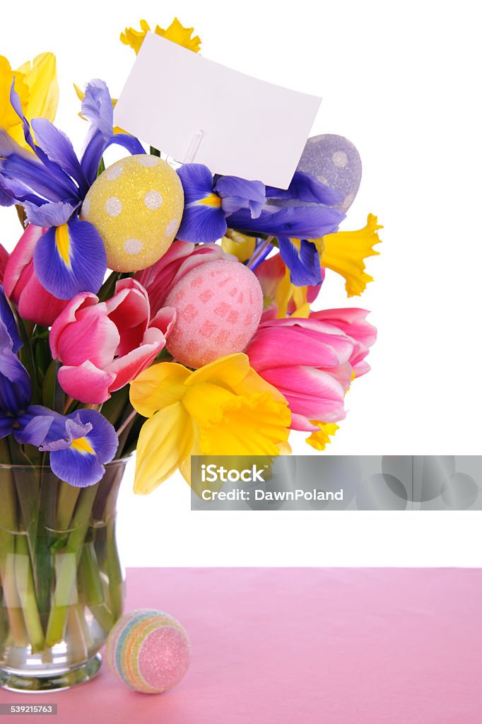 Bouquet Of Flowers With Eggs A beautiful bouquet of flowers with a card and eggs on a white background. Blue Stock Photo