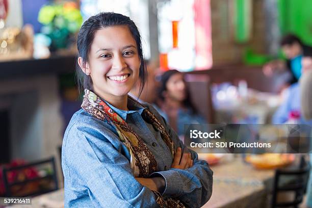 Pretty Hispanic Young Woman Standing In Family Owned Texmex Restaurant Stock Photo - Download Image Now