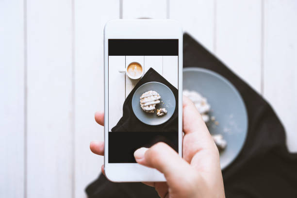 istock hand taking photo of tabletop 539216616