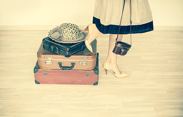 istock Woman standing beside suitcases 539217018