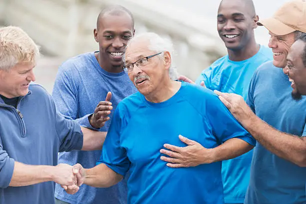 Photo of Group of men with senior Hispanic man in center