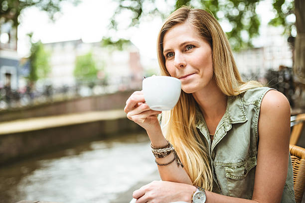 istock Smiling woman holding a coffee cup 539217077