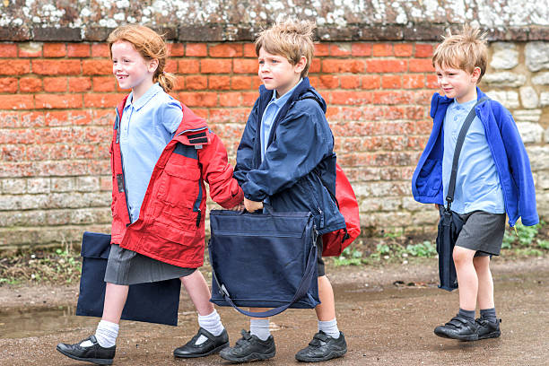 Children walking to UK primary school stock photo