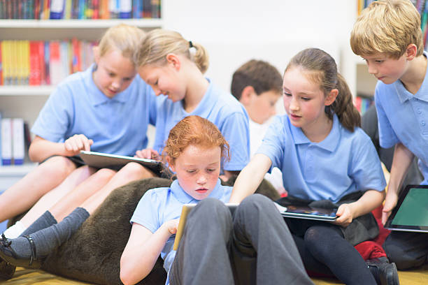 UK School children using technolgy stock photo